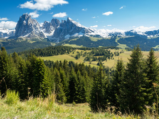 Fototapeta na wymiar Blue sky with clouds, green grass. View into the Val Gardena near Ortisei,South Tirol,Italy. September, 2017