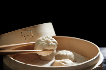 Raw baozi dumpling on white background