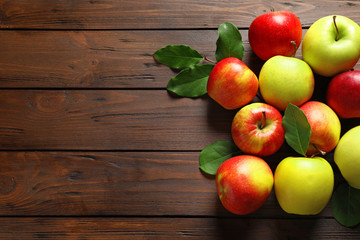 Ripe juicy apples on wooden table