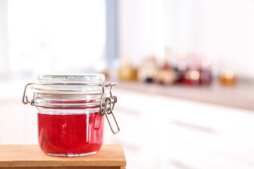 Jar with sweet jam on wooden crate