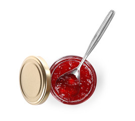 Jar and spoon with sweet jam on white background