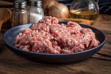 Minced meat on wooden background.