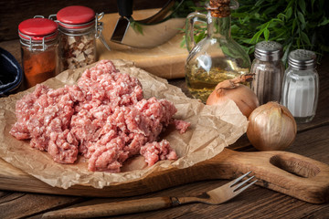Minced meat on wooden background.