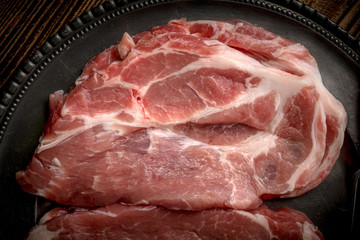 Slices of raw pork neck.