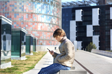 Teenage boy typing text message.Using smart phone