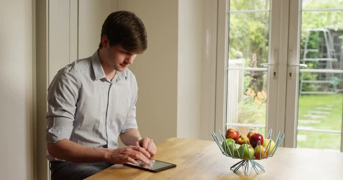4k, Young businessman working on his digital tablet from home. Slow motion.