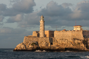 The fortress and the lighthouse of El Morro in the entrance of Havana bay, Cuba. At sunset