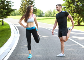 Two runners sprinting outdoors - Sportive people training in a urban area, healthy lifestyle and sport concepts