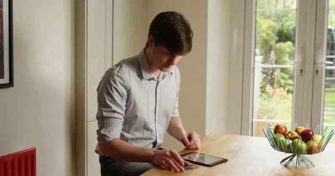 4k, Young businessman working on his digital tablet from home. Slow motion.