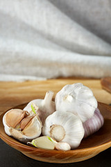 Garlic close up on wooden plate on black board,shallow depth of field, selective focus, macro
