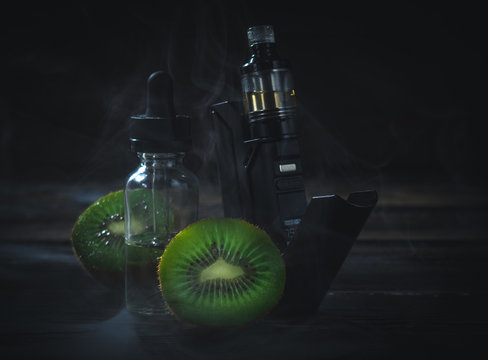 black vaporizer in the smoke with sliced kiwi