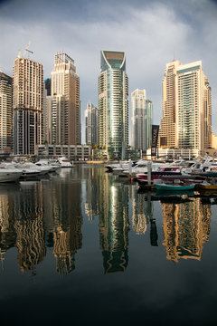 DUBAI, UAE - FEBRUARY 2018: View of modern skyscrapers shining in sunrise lights  in Dubai Marina in Dubai, UAE.