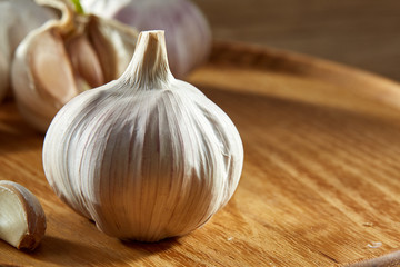 Garlic close up on rustic wooden background, shallow depth of field, selective focus, macro