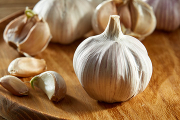 Garlic close up on rustic wooden background, shallow depth of field, selective focus, macro