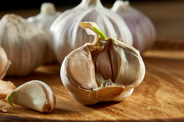 Garlic close up on rustic wooden background, shallow depth of field, selective focus, macro