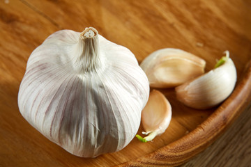 Garlic close up on rustic wooden background, shallow depth of field, selective focus, macro