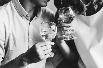 Glasses in the hands of a couple in love