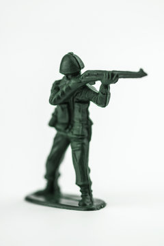 Classic green toy army soldier aiming his gun.