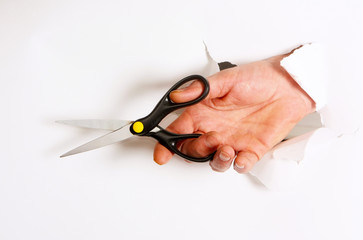 Fingers cut with scissors through a hole on a white background. Concept of a man's hand with a...