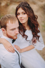 stylish couple posing at the wedding. rustic style. groom with beard