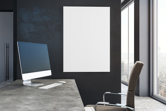 Blank computer and poster in office