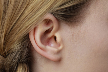 Close up on female ear and braid hair
