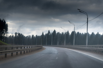 road in forest. metal safety barrier