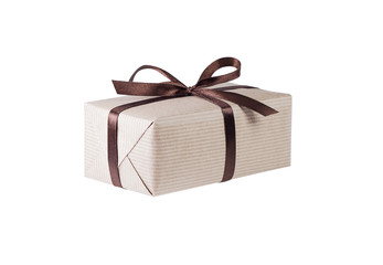 Gift box or present wrapped in brown craft paper and decorated satin ribbon knotted on a bow isolated on white background