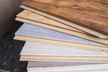 Samples of laminate and parquet board. Selection and types of floor coverings.