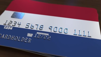 Plastic bank card featuring flag of the Netherlands. National banking system related animation - Powered by Adobe