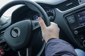 hand on a steering wheel driving