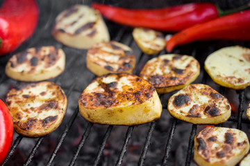 Hot Outdoor BBQ Grill With A Cut Potatoes Pieces, Red Peppers And Tasty Chicken Breast Meat