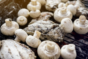 Hot Outdoor BBQ Grill With A Lot Of Mushrooms And Tasty Chicken Breast Meat