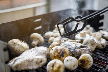 Turning Pieces Of Hot Outdoor BBQ Grill With A Lot Of Mushrooms And Tasty Chicken Breast Meat