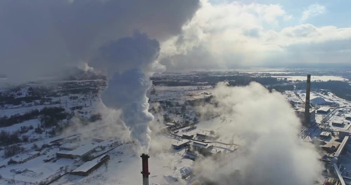Aerial view of gas processing plant at winter time. Aerial view of factory smoke stack - Oil refinery, petrochemical or chemical plant in winter