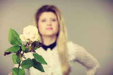Pretty woman with white rose flower
