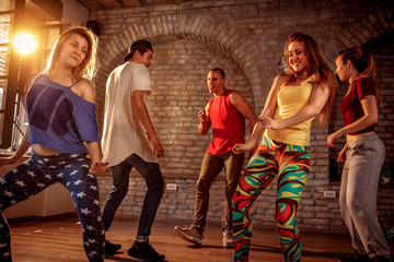 Group of modern dancers dancing in the studio. Sport, dancing and urban concept