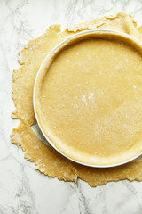 Rolling a pastry for baking a pie and pricking it with fork. Recipe concept
