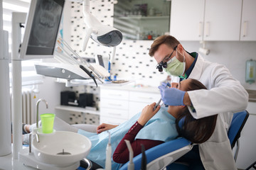 Fototapeta na wymiar Dental specialist checking up patient’s teeth