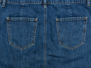Fototapeta premium Part of the blue denim skirt. Wooden background, fashionable concept