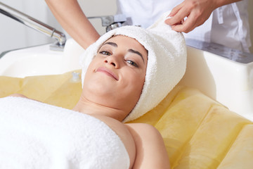 Female Enjoying Relaxing on Massage water bed In Cosmetology Spa Center