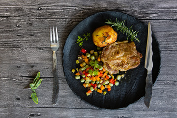 Grilled pork with roasted vegetables and baked potato