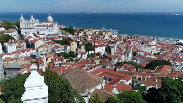 Urban aerial downtown Lisbon capital and the largest city of Portugal showing in background Monastery of Sao Vicente de Fora and the church of Santa Engracia in Portuguese Igreja de Santa Engracia 4k