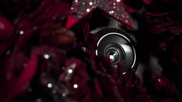 Closeup on a peephole in the middle of a Christmas wreath