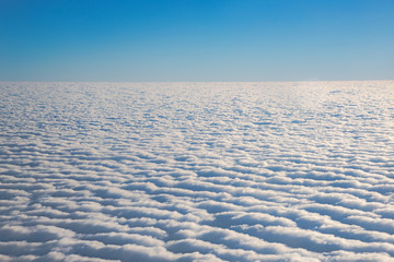 Fototapeta na wymiar Cloud view through airplane window.