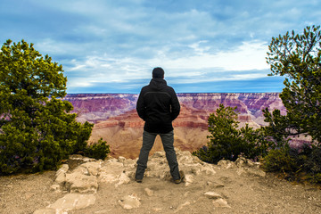 Fototapeta premium Astonished man in the Grand Canyon, looking the view