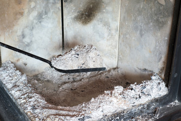Man cleaning fireplace from ashes