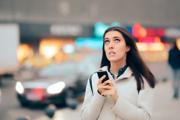 Stressed Woman Checking her Phone Walking on the Street