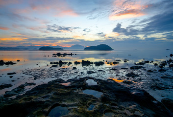 Sunrise on the stones at sea at low tide, Krabi, Andaman coast, Thailand