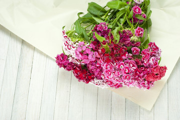 bunch of sir williams flowers on white wooden table